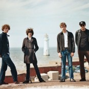 Five men stood on a pier